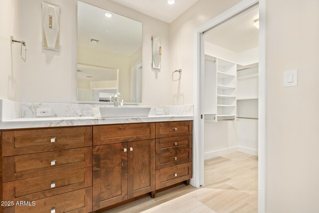 6102 E Aster Dr, Scottsdale, AZ 85254 - bathroom featuring vanity, a spacious closet, and recessed lighting