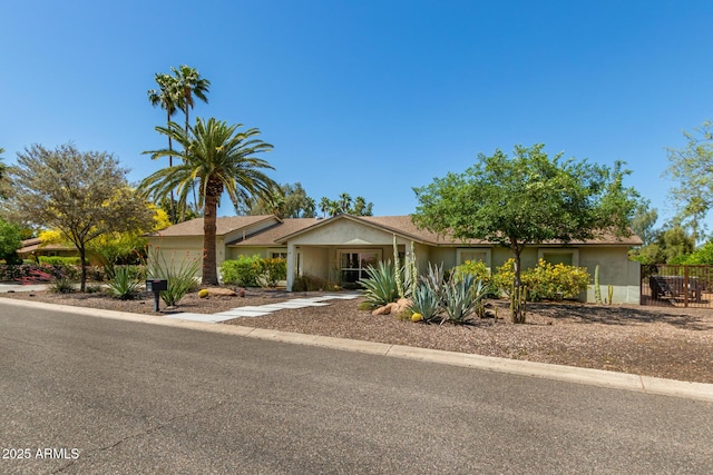 6102 E Aster Dr, Scottsdale, AZ 85254 - view of front of house featuring concrete driveway, an attached garage, and stucco siding