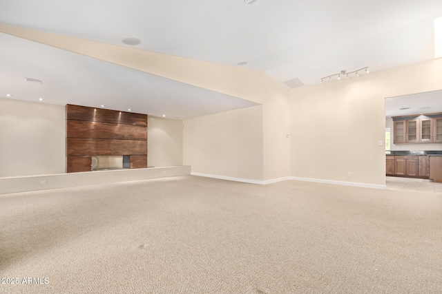 6102 E Aster Dr, Scottsdale, AZ 85254 - unfurnished living room featuring light colored carpet, track lighting, and vaulted ceiling