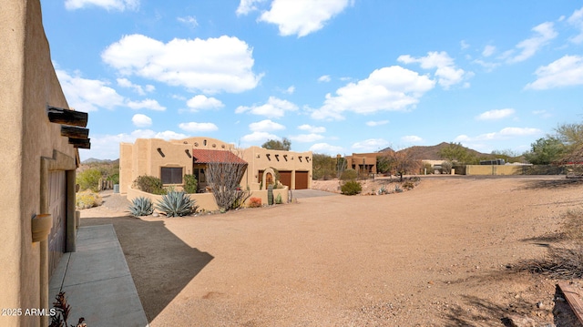 view of yard with a mountain view and driveway