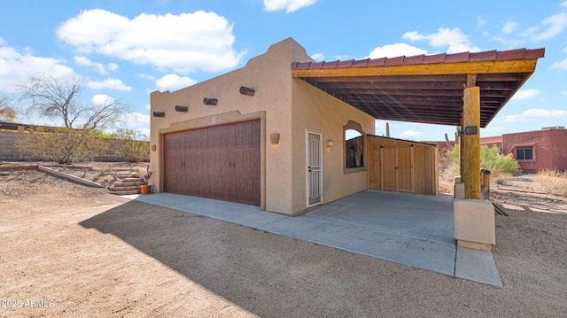 garage featuring a carport and driveway