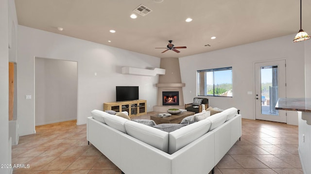 living area with ceiling fan, recessed lighting, visible vents, and a large fireplace