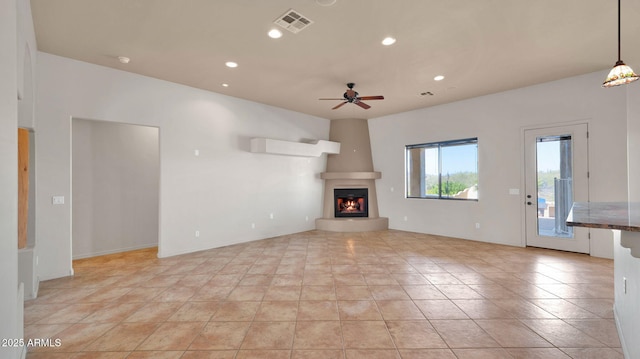 unfurnished living room featuring recessed lighting, visible vents, ceiling fan, and a fireplace