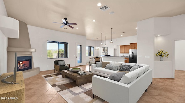 living room featuring light tile patterned floors, visible vents, recessed lighting, ceiling fan, and a large fireplace