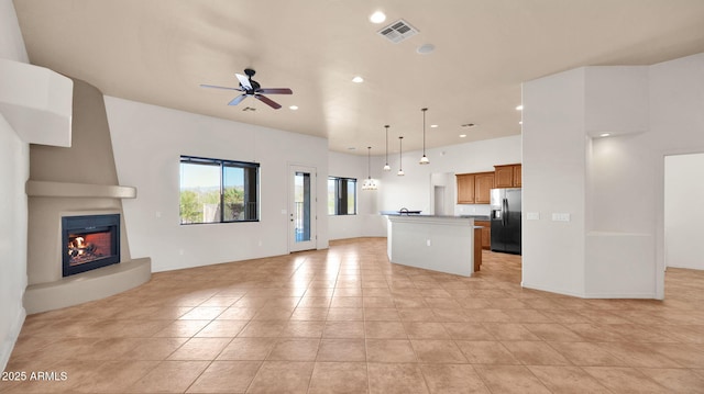 unfurnished living room featuring light tile patterned floors, a ceiling fan, visible vents, recessed lighting, and a fireplace