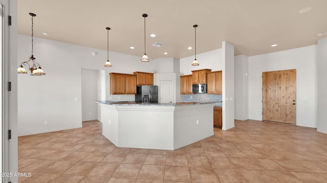 kitchen featuring visible vents, decorative backsplash, stainless steel microwave, decorative light fixtures, and black refrigerator with ice dispenser