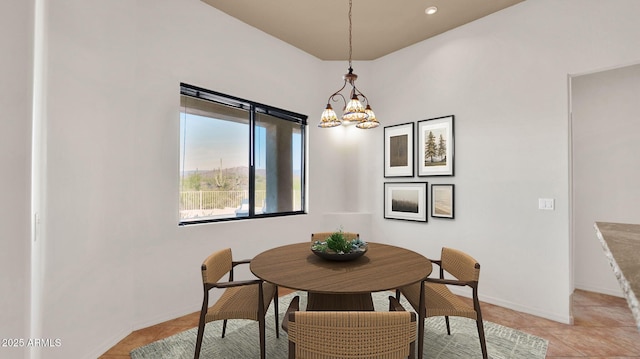 dining area featuring light tile patterned floors, baseboards, and an inviting chandelier