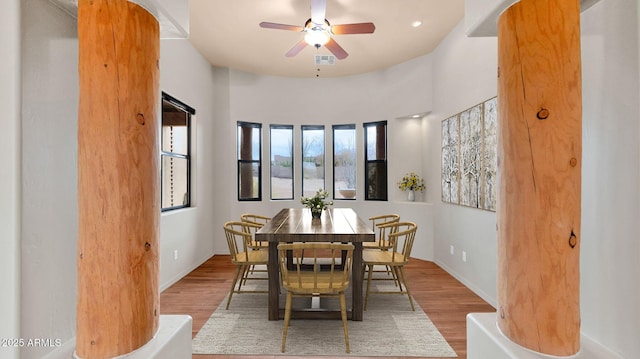 dining area with ceiling fan, visible vents, baseboards, and wood finished floors