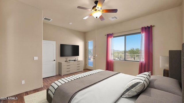 bedroom with visible vents, baseboards, ceiling fan, and wood finished floors