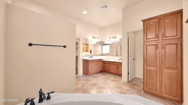 full bath with vanity, a bathtub, visible vents, and tile patterned flooring