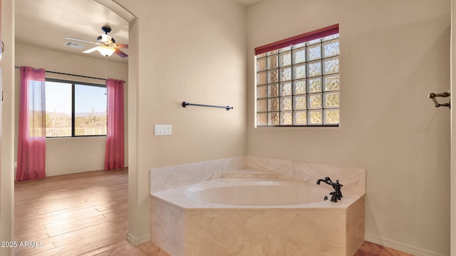 full bathroom with visible vents, a garden tub, and ceiling fan