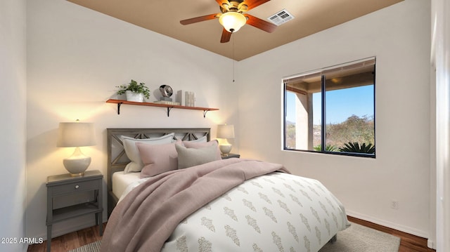 bedroom with visible vents, baseboards, and dark wood-style flooring