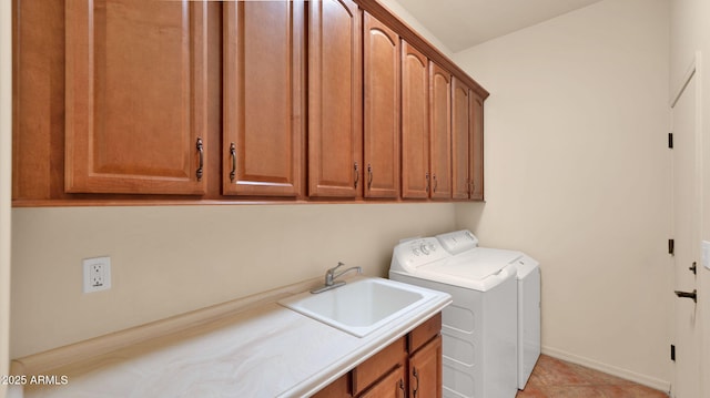 laundry room with washer and dryer, cabinet space, baseboards, and a sink