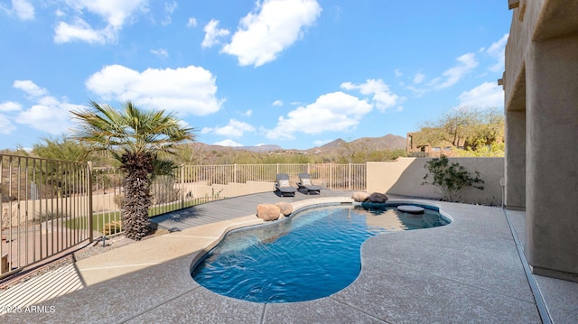 view of swimming pool with a fenced backyard, a fenced in pool, a mountain view, and a patio