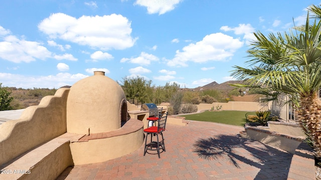 view of patio featuring exterior kitchen and a fenced backyard