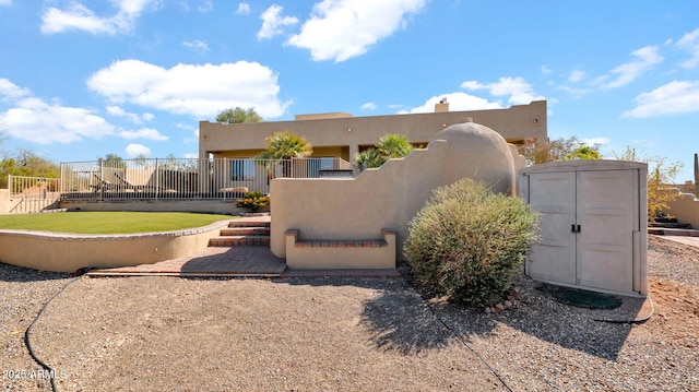 southwest-style home with a fenced front yard and stucco siding