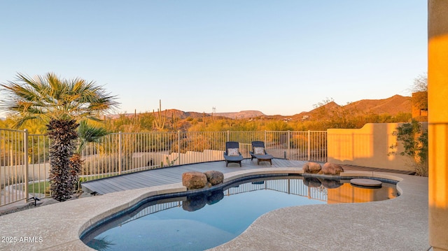 view of pool with a patio area, a fenced in pool, a mountain view, and fence