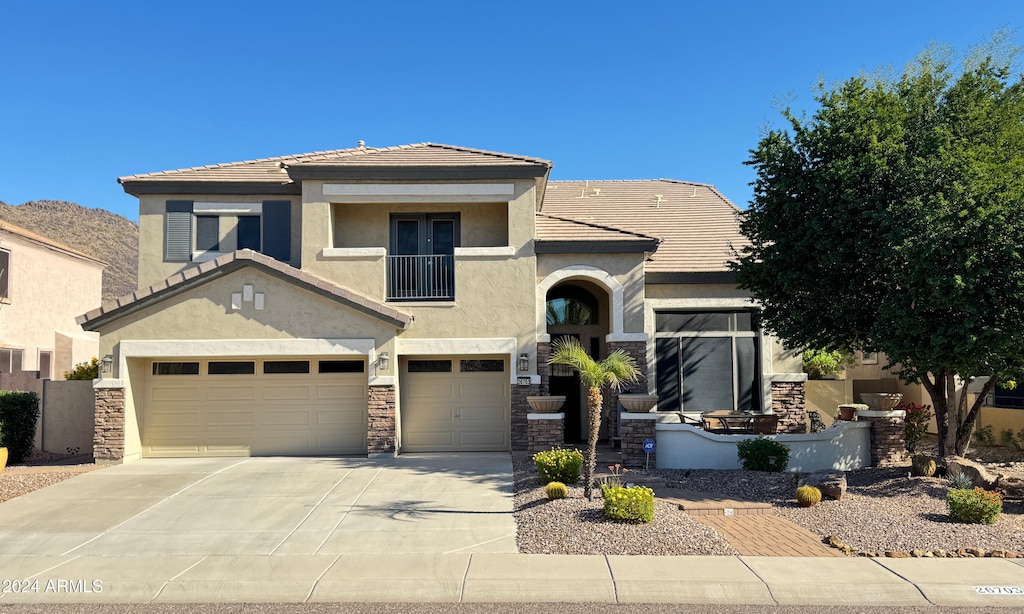 view of front of home featuring a garage and a balcony