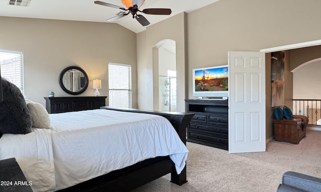 bedroom featuring multiple windows, ceiling fan, light colored carpet, and lofted ceiling