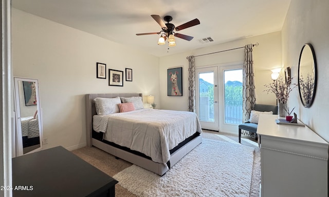 bedroom featuring ceiling fan, access to exterior, and light colored carpet