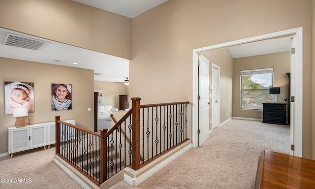 hallway with light colored carpet