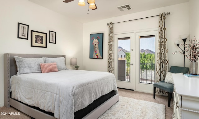 bedroom with ceiling fan, light carpet, and access to outside