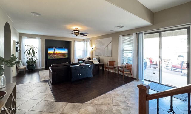 living room with ceiling fan and light wood-type flooring