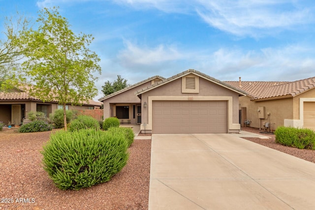 ranch-style house with stucco siding, an attached garage, driveway, and a tile roof