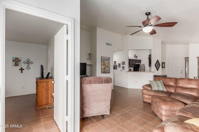 living area with light tile patterned flooring, ceiling fan, and lofted ceiling