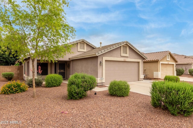 ranch-style house featuring a garage, stucco siding, concrete driveway, and a tile roof