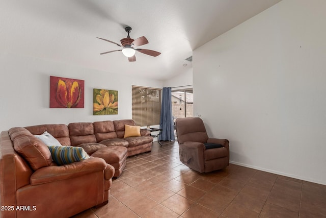 living area with ceiling fan, lofted ceiling, light tile patterned flooring, and baseboards