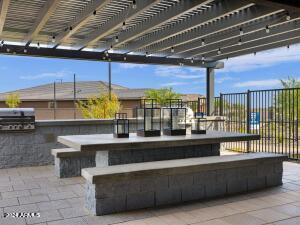 view of patio with an outdoor kitchen, grilling area, and a pergola