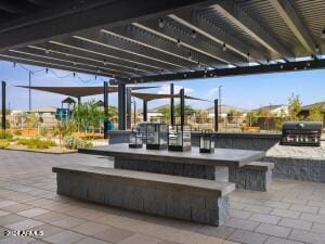 view of patio featuring a bar and area for grilling