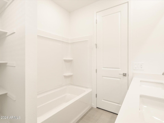 bathroom featuring shower / washtub combination, tile patterned flooring, and vanity