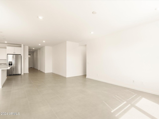 unfurnished room with light tile patterned floors