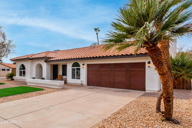 mediterranean / spanish-style house featuring a garage