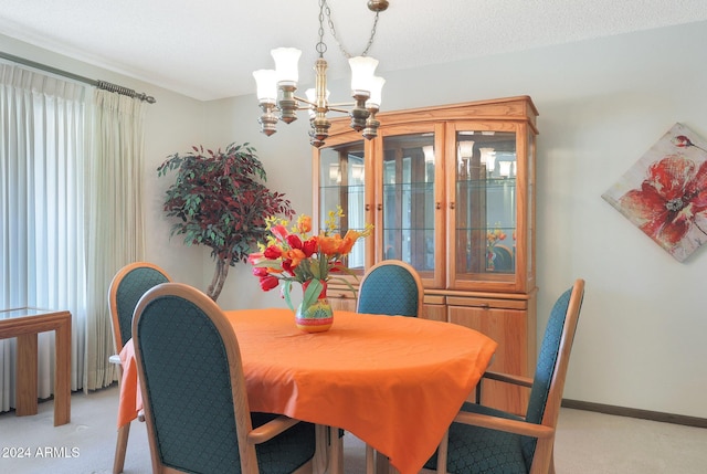 carpeted dining area with a chandelier and a textured ceiling