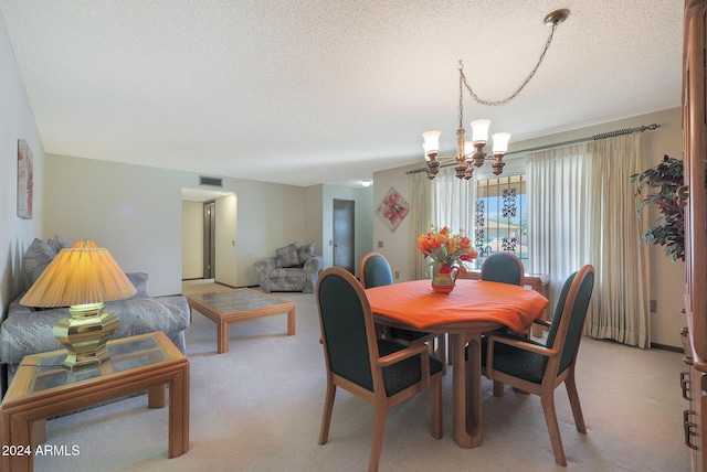 dining room featuring light colored carpet, a textured ceiling, and a notable chandelier