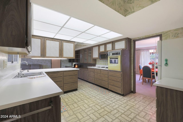 kitchen featuring decorative backsplash, sink, and oven