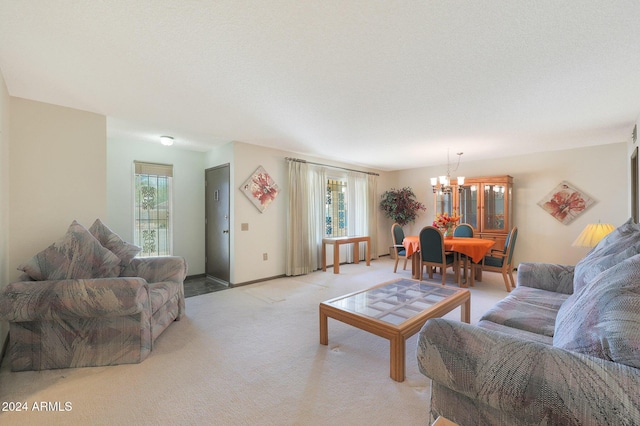 carpeted living room featuring a textured ceiling and an inviting chandelier