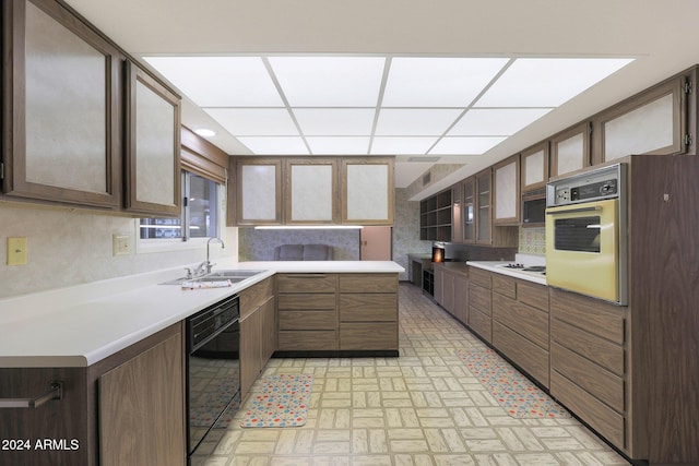 kitchen featuring backsplash, white appliances, and sink