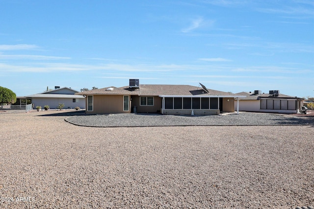 single story home with a sunroom and central AC