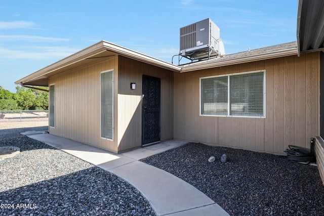 view of exterior entry featuring central AC