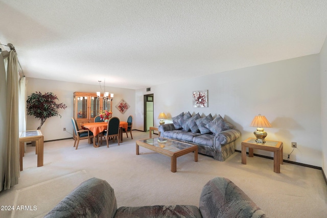 living room featuring light carpet, a textured ceiling, and a notable chandelier