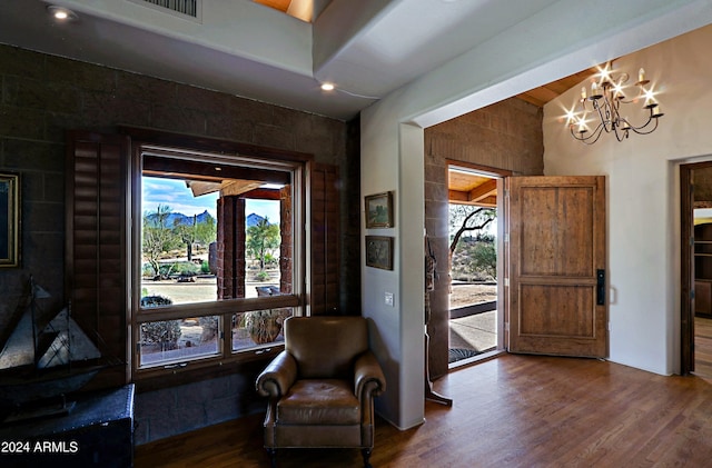 living area featuring dark hardwood / wood-style floors, plenty of natural light, and a notable chandelier