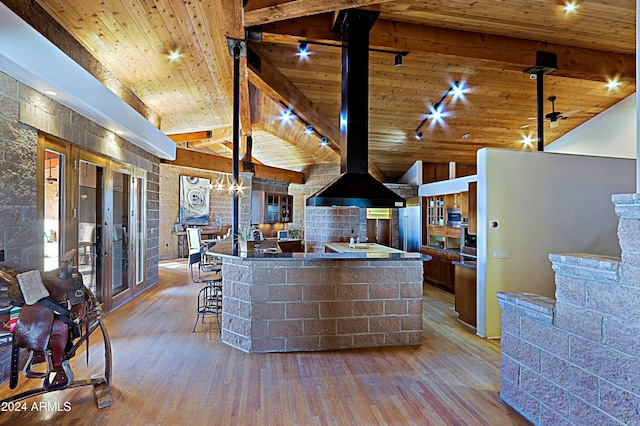 kitchen featuring wood ceiling, french doors, a wood stove, lofted ceiling with beams, and light hardwood / wood-style flooring