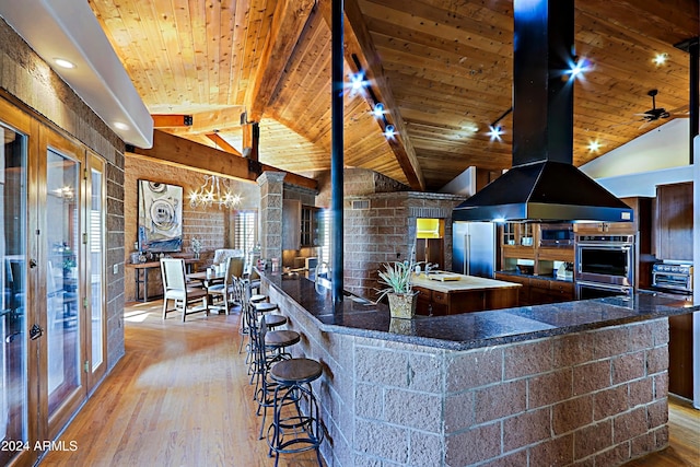 kitchen with wooden ceiling, a spacious island, and lofted ceiling with beams