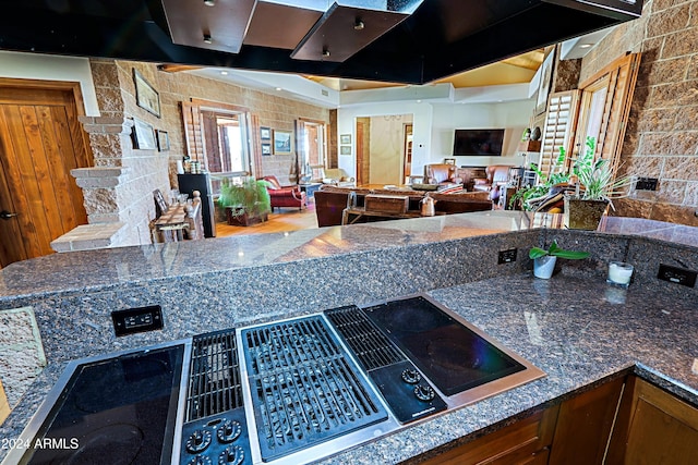 kitchen with stovetop and stone counters