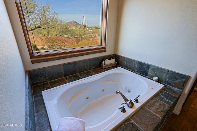 bathroom featuring a relaxing tiled tub