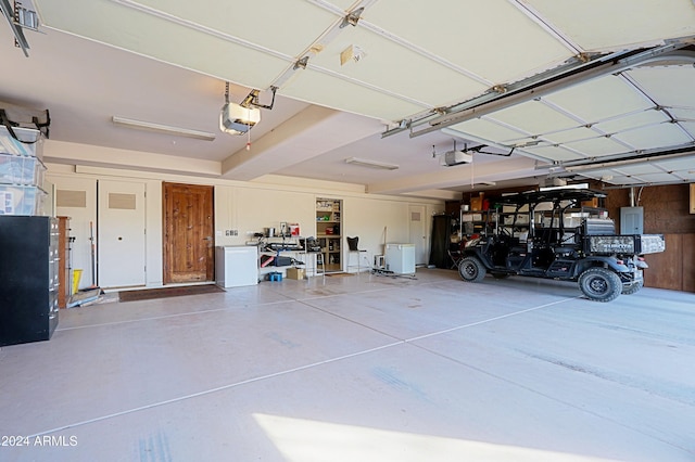 garage featuring a garage door opener and electric panel